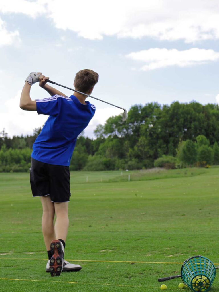 Junge spielt Golf